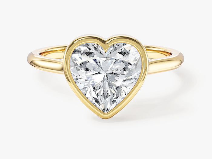 Heart cut lab grown diamond bezel set engagement ring in yellow gold, front view