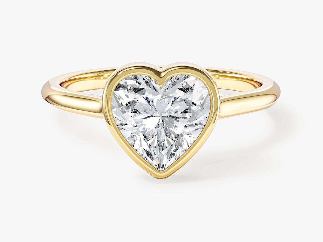 Heart cut moissanite bezel set solitaire engagement ring in yellow gold, front view