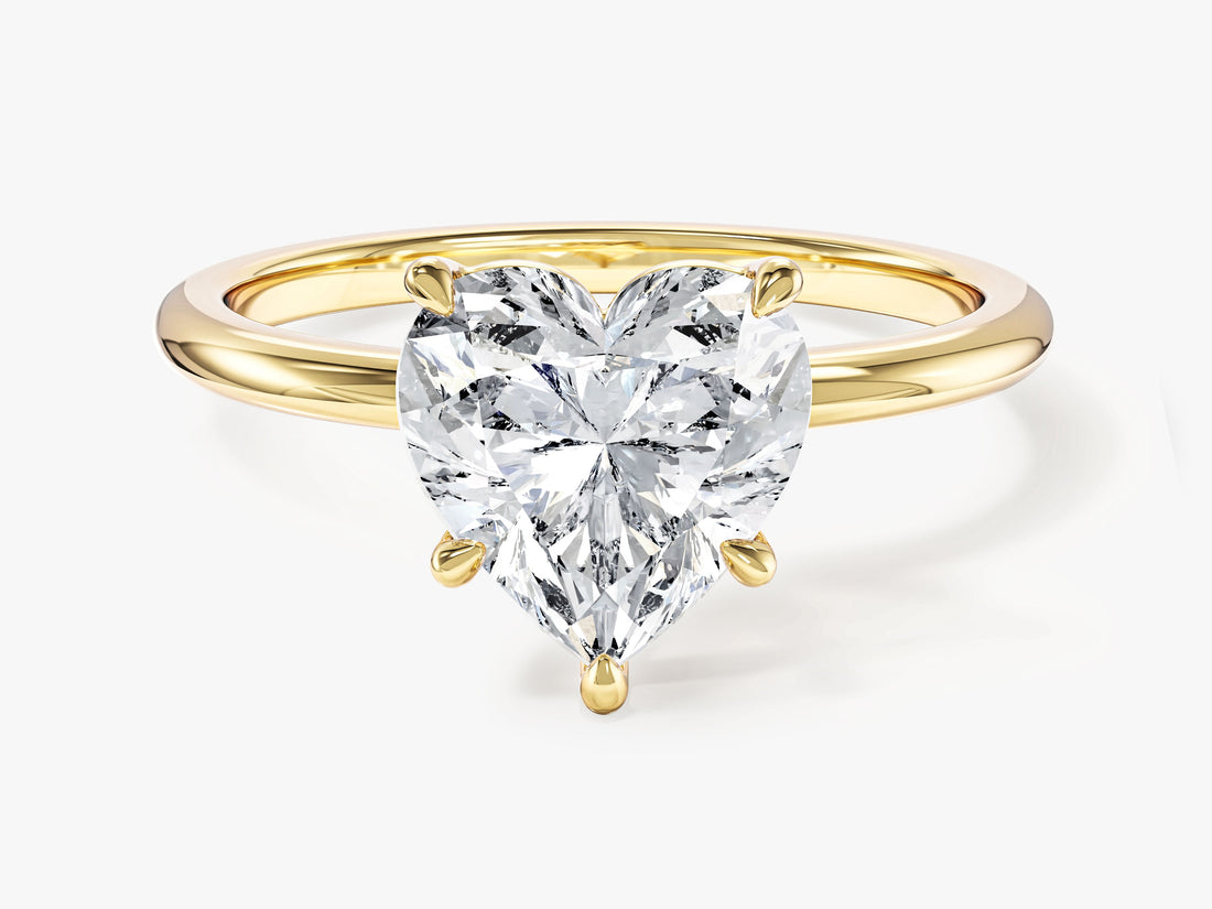 Heart cut lab grown diamond minimalist solitaire in yellow gold, front view showing five claws