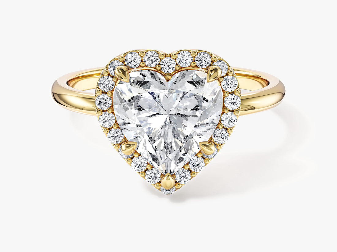 Heart shaped moissanite halo engagement ring with plain band in yellow gold, front view