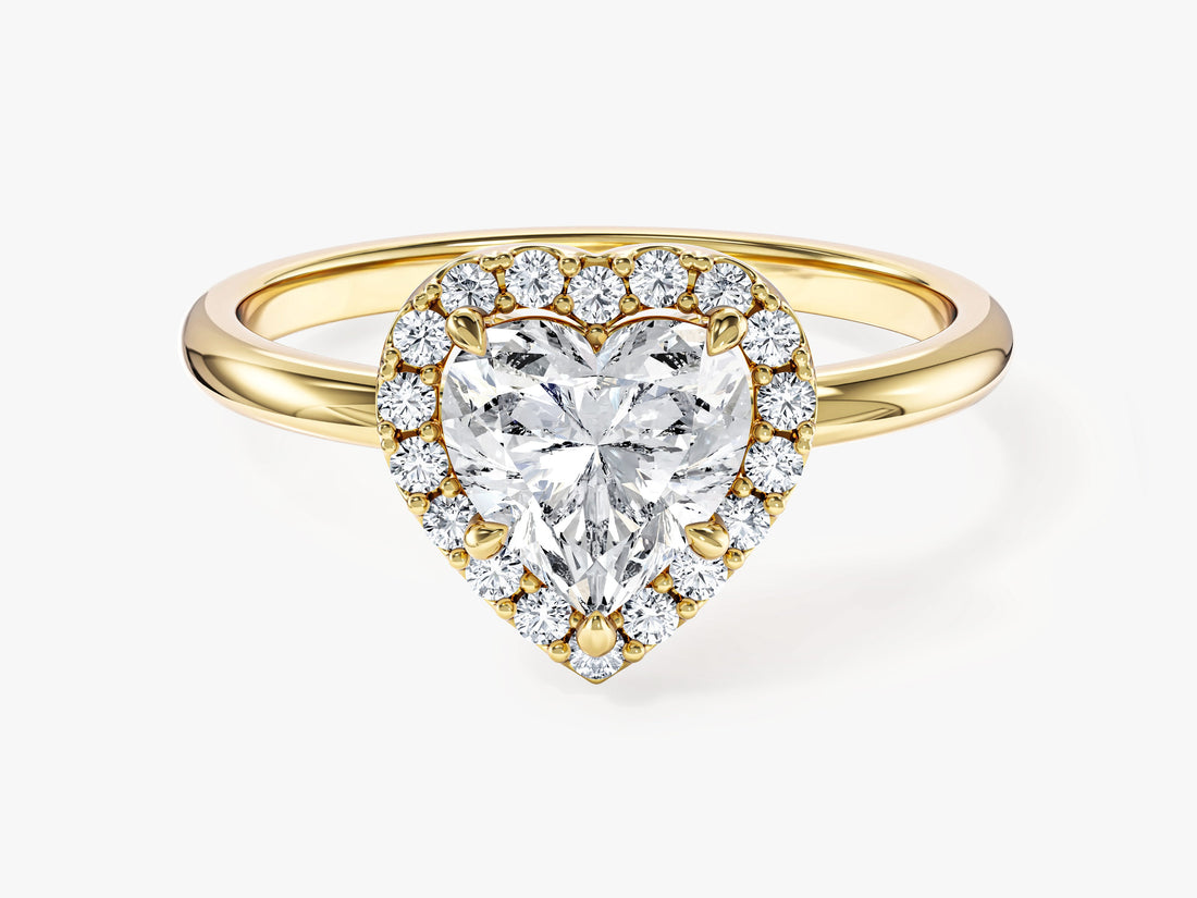 Dainty heart moissanite halo engagement ring on a slim band in yellow gold, front view