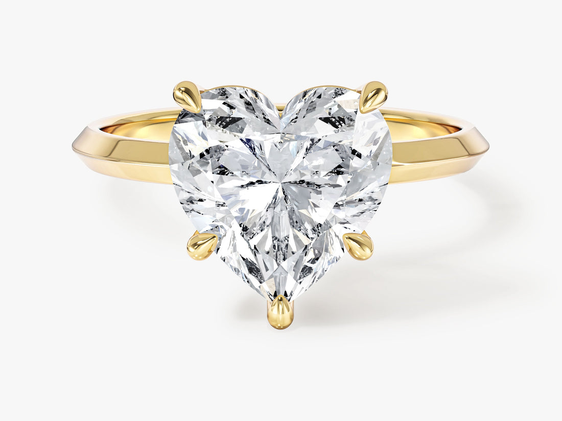 Heart shaped moissanite knife edge solitaire engagement ring in yellow gold, front view showing five claws