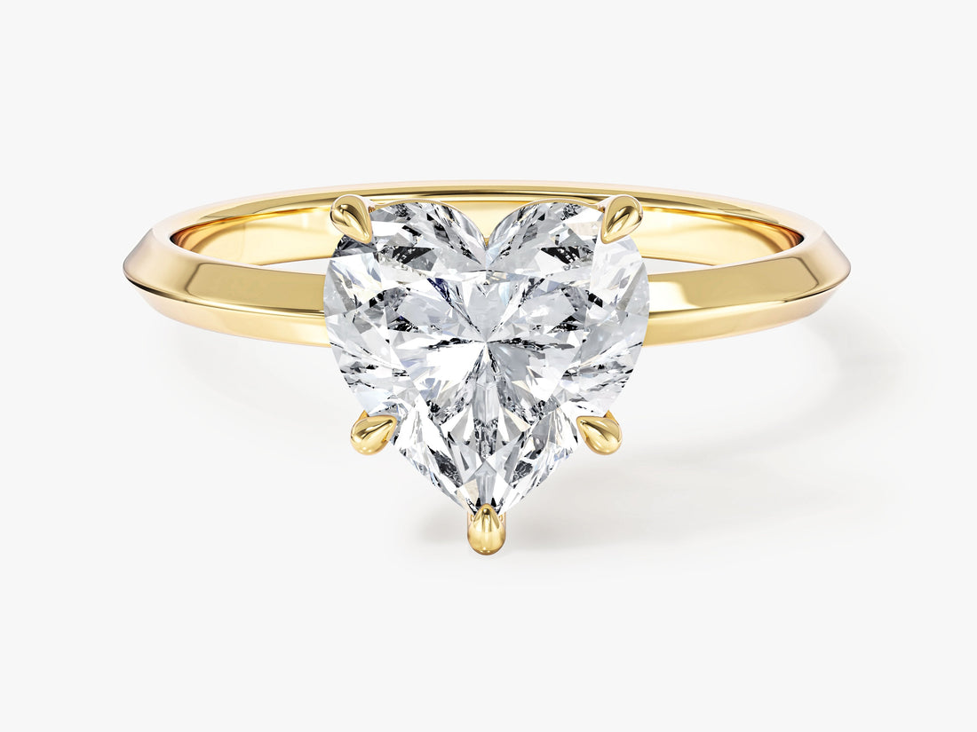 Heart cut moissanite knife edge solitaire engagement ring in yellow gold, front view
