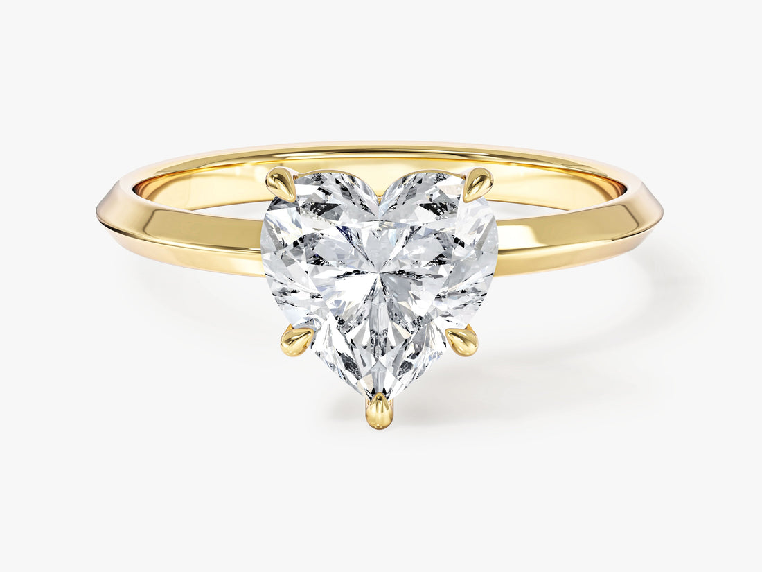 Knife edge band heart moissanite engagement ring in yellow gold, front view