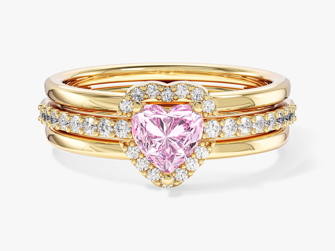 Heart moissanite micro pave engagement ring in yellow gold stacked inside an open heart enhancer, front view, shown with a pink sample stone