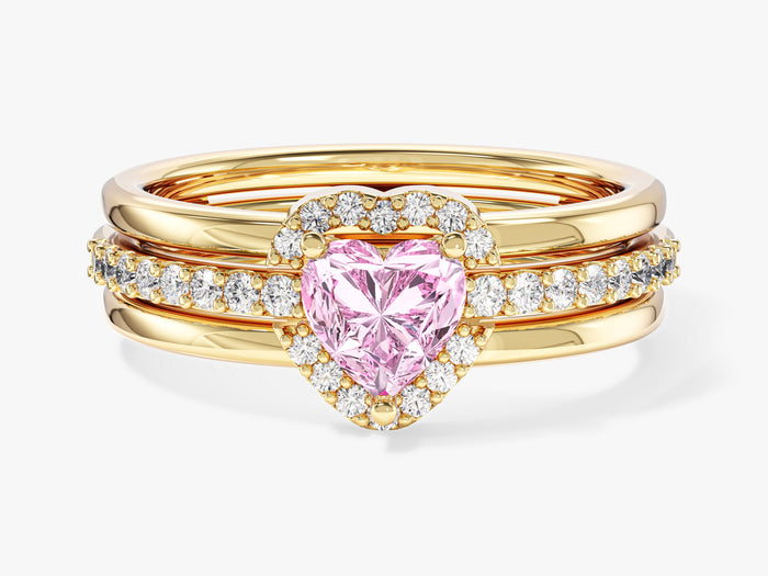 Heart moissanite micro pave engagement ring in yellow gold stacked inside an open heart enhancer, front view, shown with a pink sample stone