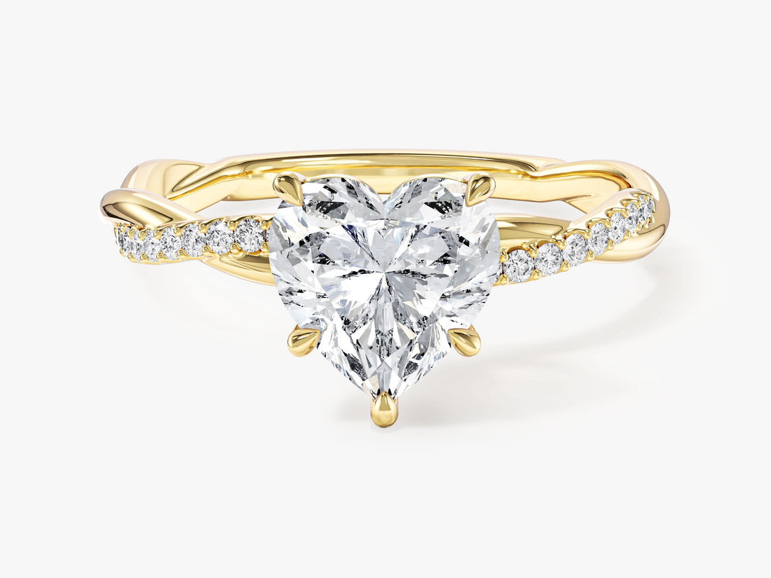 Heart cut moissanite infinity twist engagement ring with pave side stones in yellow gold, front view