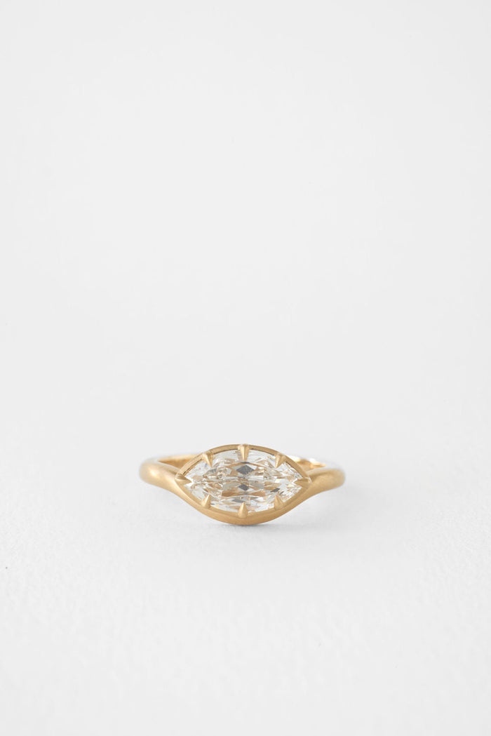 East west marquise moissanite brushed gold bezel engagement ring in yellow gold