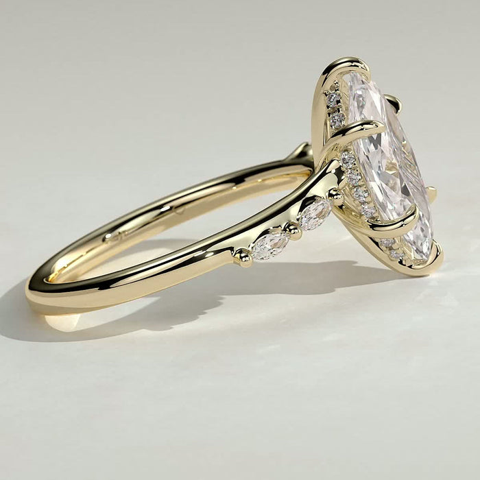 Marquise moissanite engagement ring on a curved band with graduated accents in yellow gold, view 2