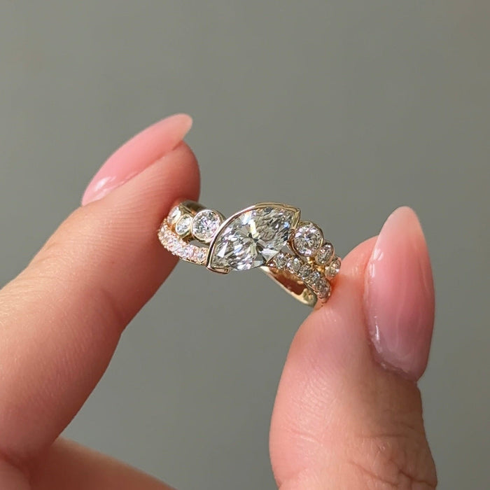 East west marquise moissanite curved pave engagement ring in yellow gold