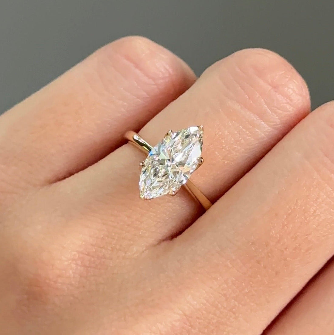 Marquise cut moissanite cathedral solitaire engagement ring in yellow gold