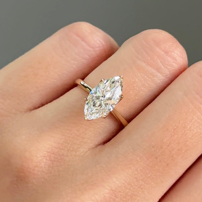 Marquise cut moissanite cathedral solitaire engagement ring in yellow gold