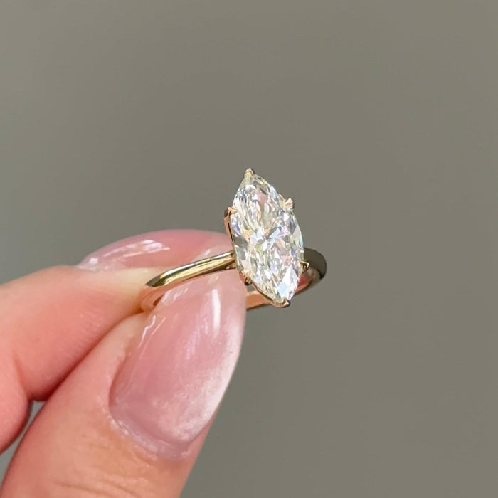 Marquise cut moissanite cathedral solitaire engagement ring in yellow gold, view 2