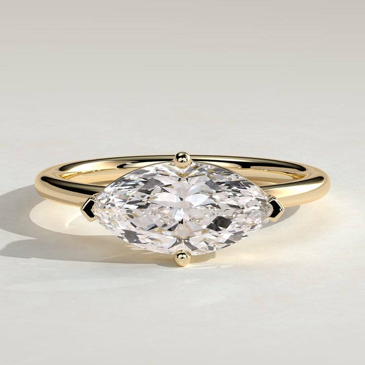 East west marquise moissanite solitaire engagement ring on a fine plain yellow gold band