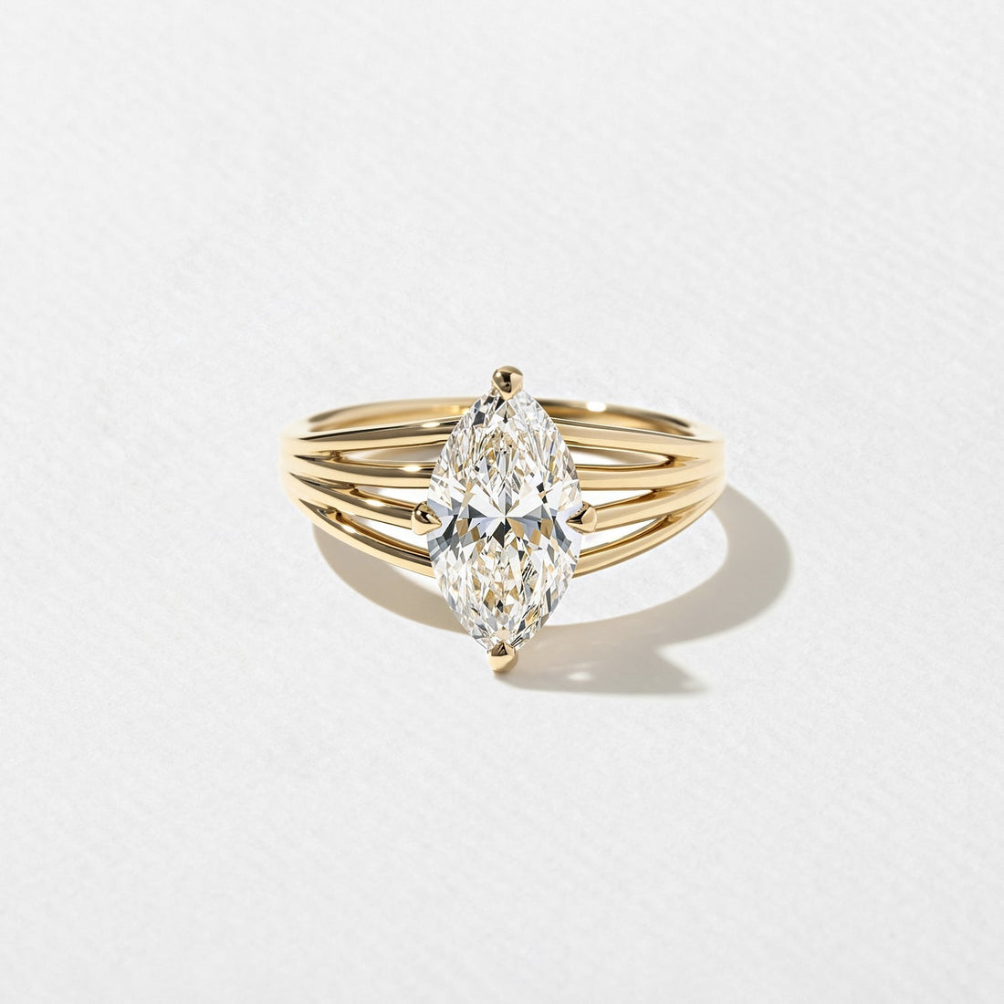 Marquise cut moissanite four rail split shank engagement ring in yellow gold
