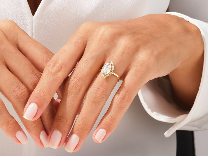 Navette marquise moissanite halo ring in yellow gold worn on the hand