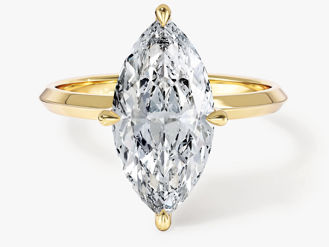 Elongated marquise moissanite knife edge statement engagement ring in 14K yellow gold, front view