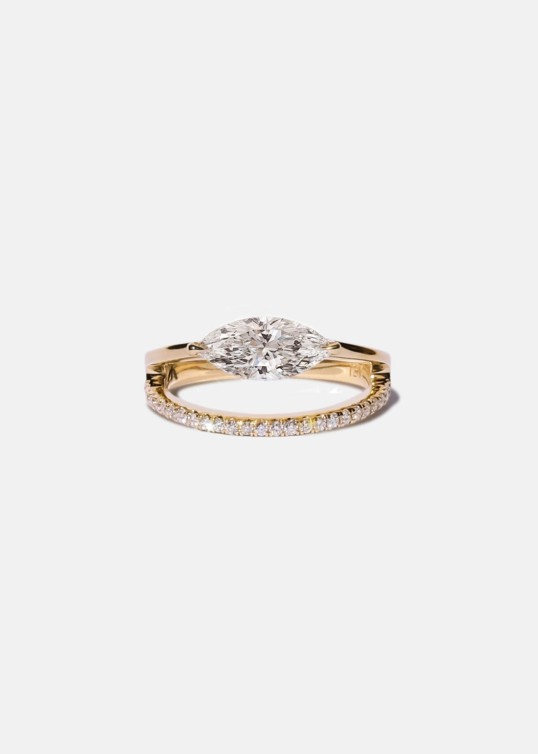 East west marquise moissanite engagement ring on a pave split shank in yellow gold