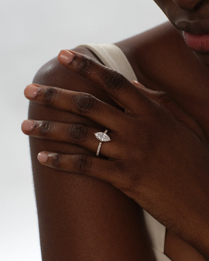 Marquise cut lab grown diamond pave ring in rose gold worn on a hand resting on the shoulder
