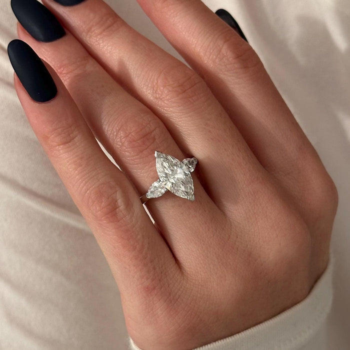 Marquise cut moissanite three stone engagement ring with pear side stones in white gold, view 2