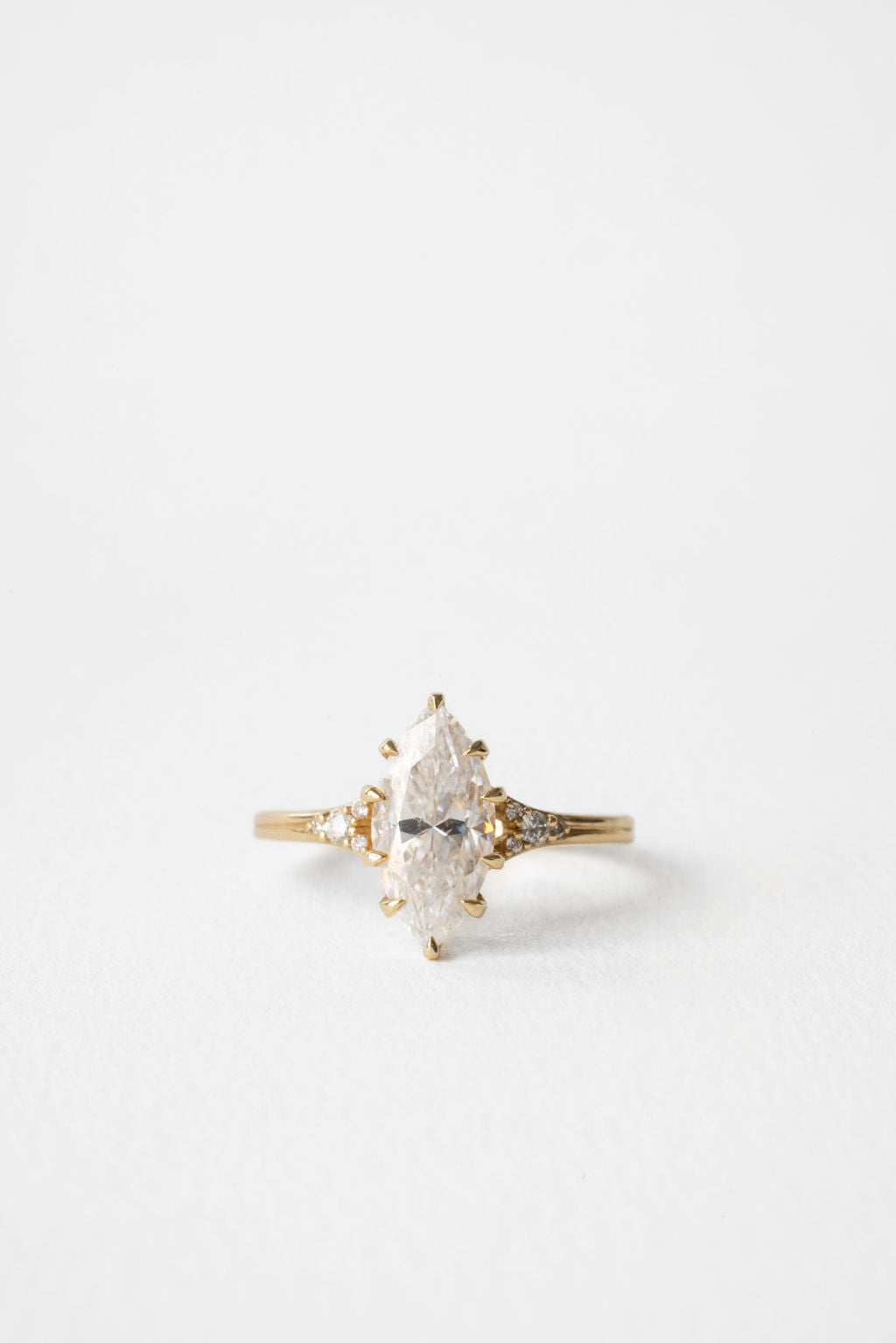 Marquise moissanite engagement ring with round cluster shoulders in yellow gold