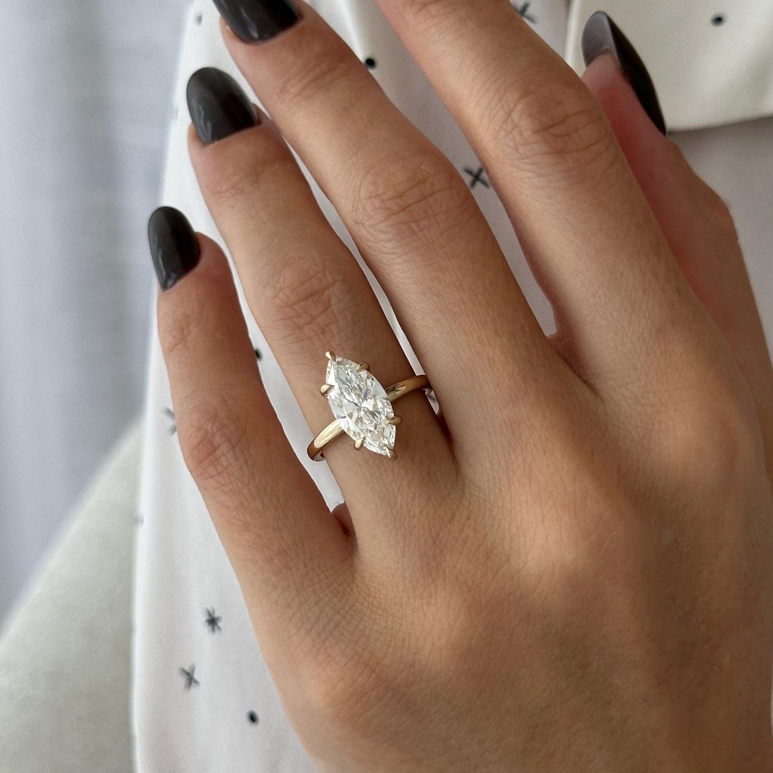 Marquise cut moissanite six claw solitaire engagement ring in yellow gold