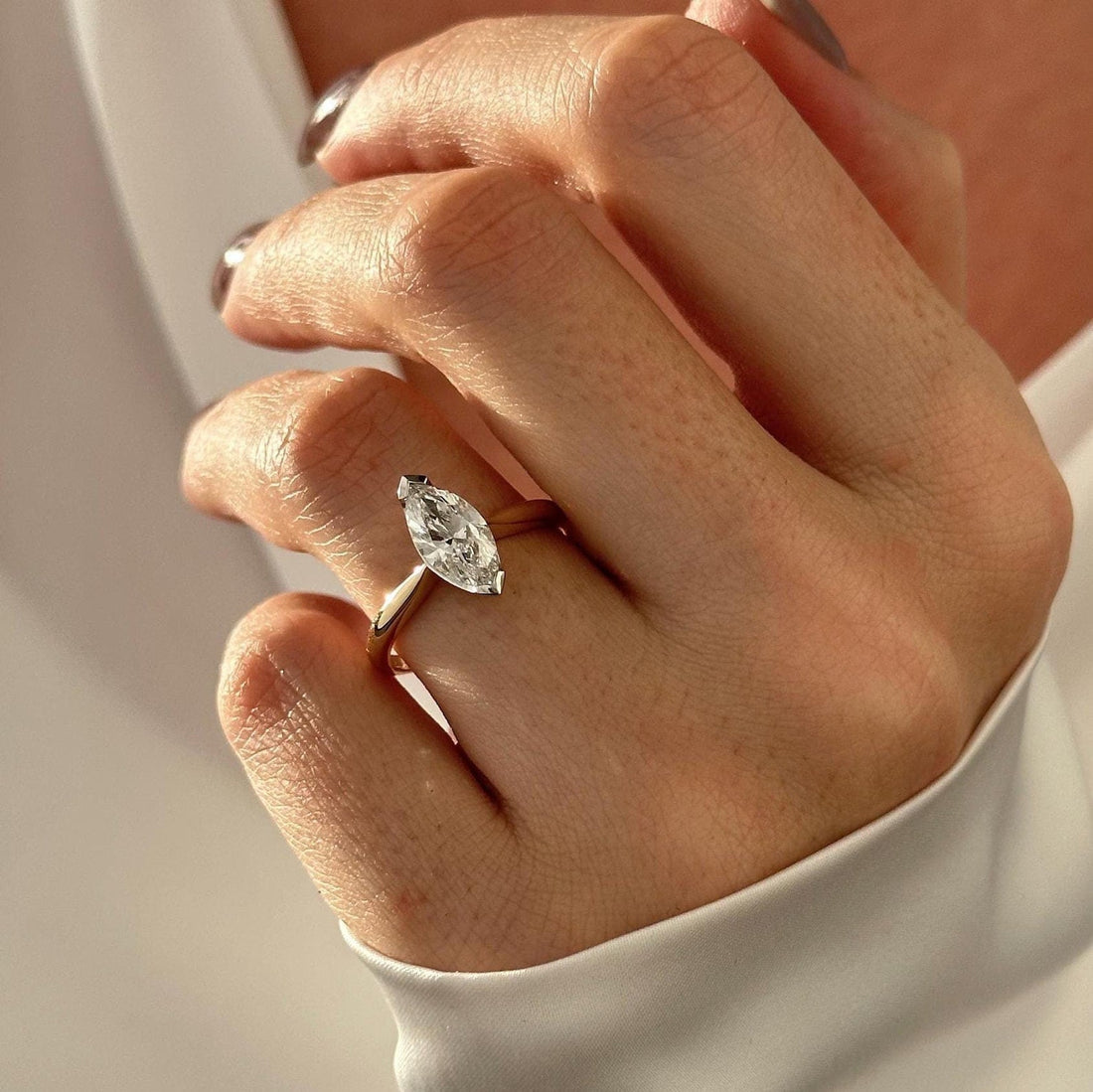 Marquise cut moissanite solitaire engagement ring in yellow gold
