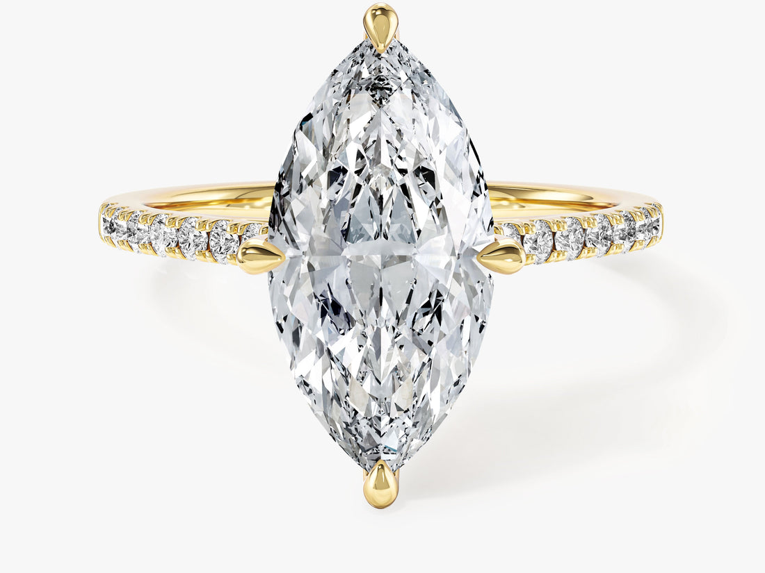 Bold marquise cut moissanite four prong engagement ring with micro pave band in 14K yellow gold, front view