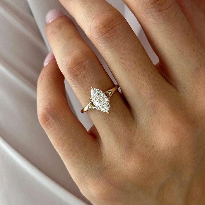 Marquise cut moissanite split shank solitaire engagement ring in yellow gold