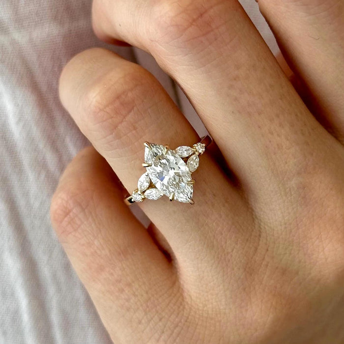 Marquise cut moissanite star cluster engagement ring in yellow gold