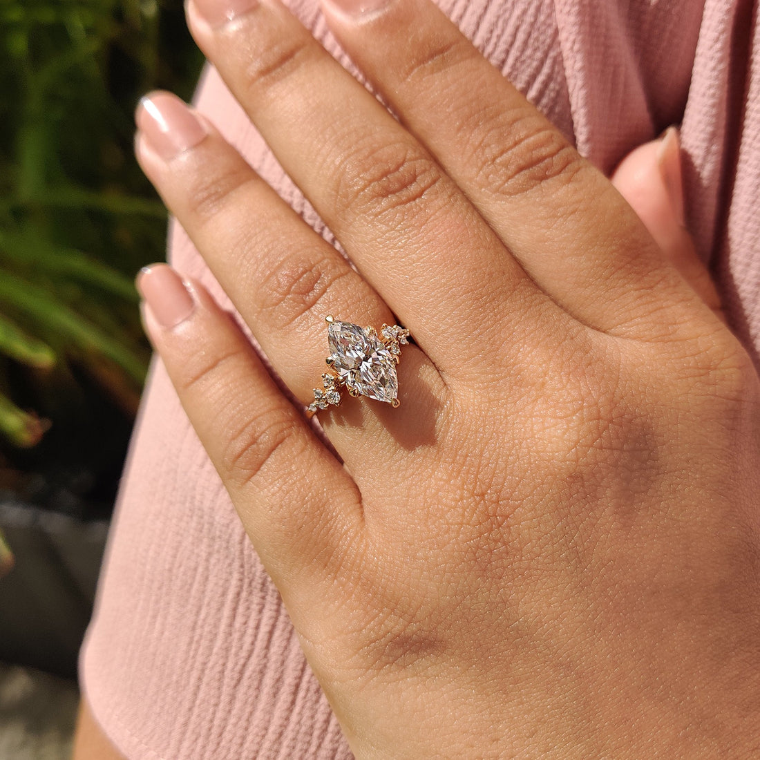 Marquise cut moissanite trio cluster shoulder engagement ring on a hairline rose gold band