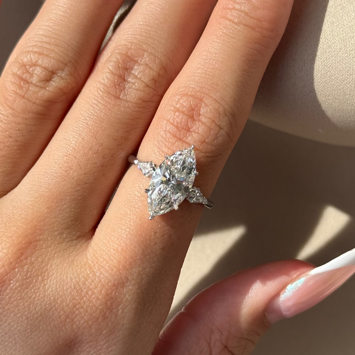 Marquise cut moissanite three stone engagement ring with kite side stones in white gold