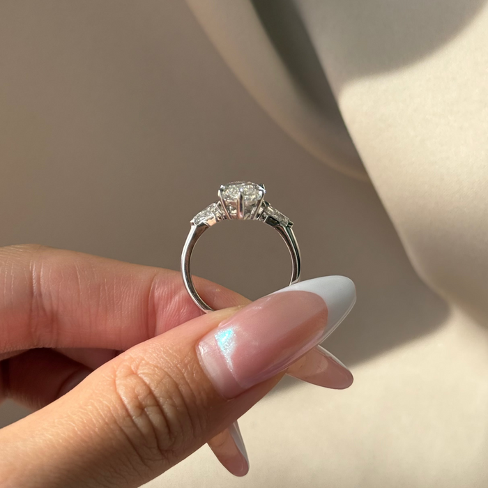 Marquise cut moissanite three stone engagement ring with kite side stones in white gold, view 2
