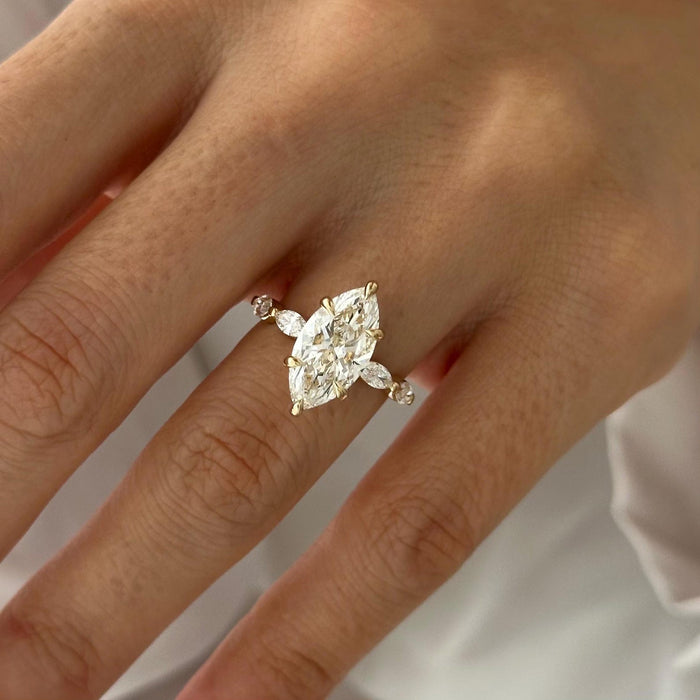Marquise cut moissanite engagement ring with angled marquise wing accents in yellow gold, view 2
