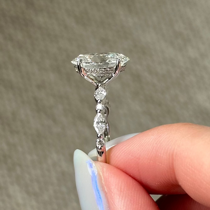 Oval cut moissanite engagement ring with marquise and round accent shoulders in white gold, view 2