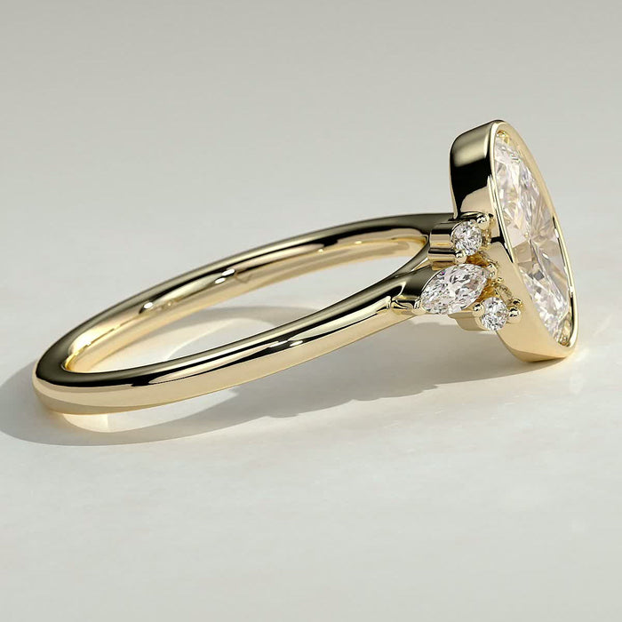 Oval cut moissanite bezel engagement ring with marquise cluster shoulders in yellow gold, view 2