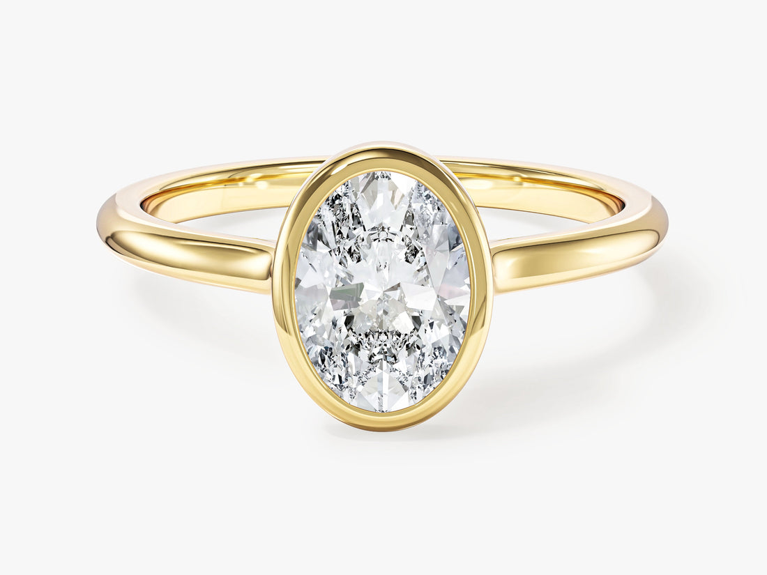 Oval moissanite bezel set solitaire engagement ring in yellow gold, front view
