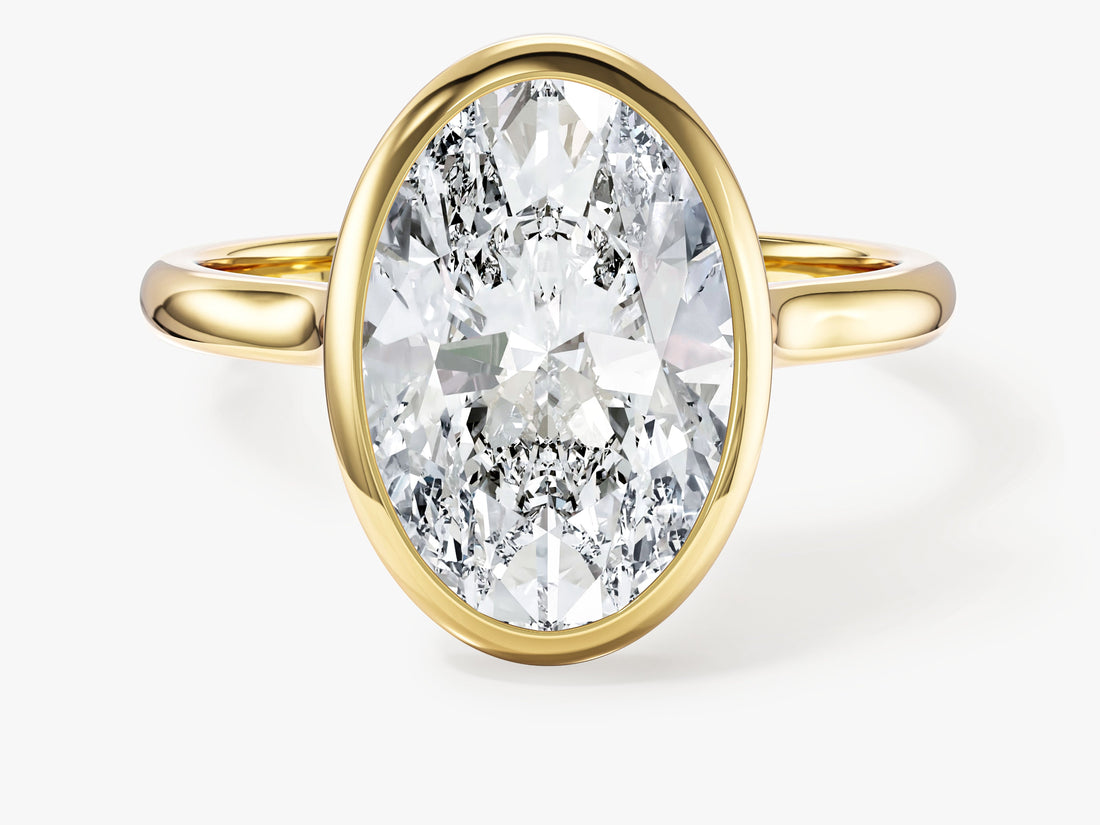 Large oval moissanite bezel solitaire engagement ring in yellow gold, front view