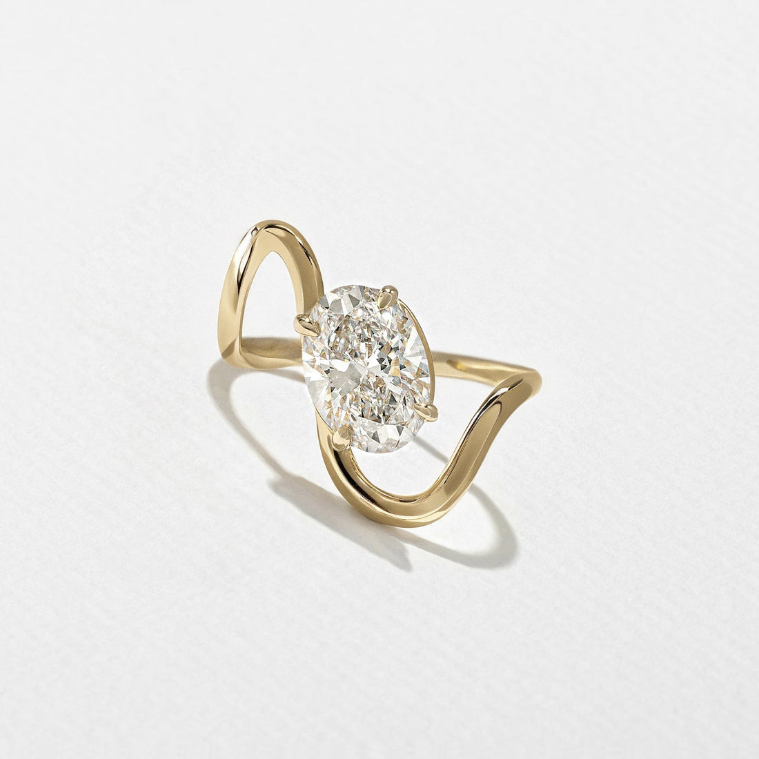 Oval cut moissanite open chevron shank solitaire engagement ring in yellow gold