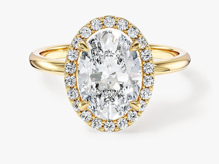 Oval moissanite classic halo engagement ring with plain band in yellow gold, front view