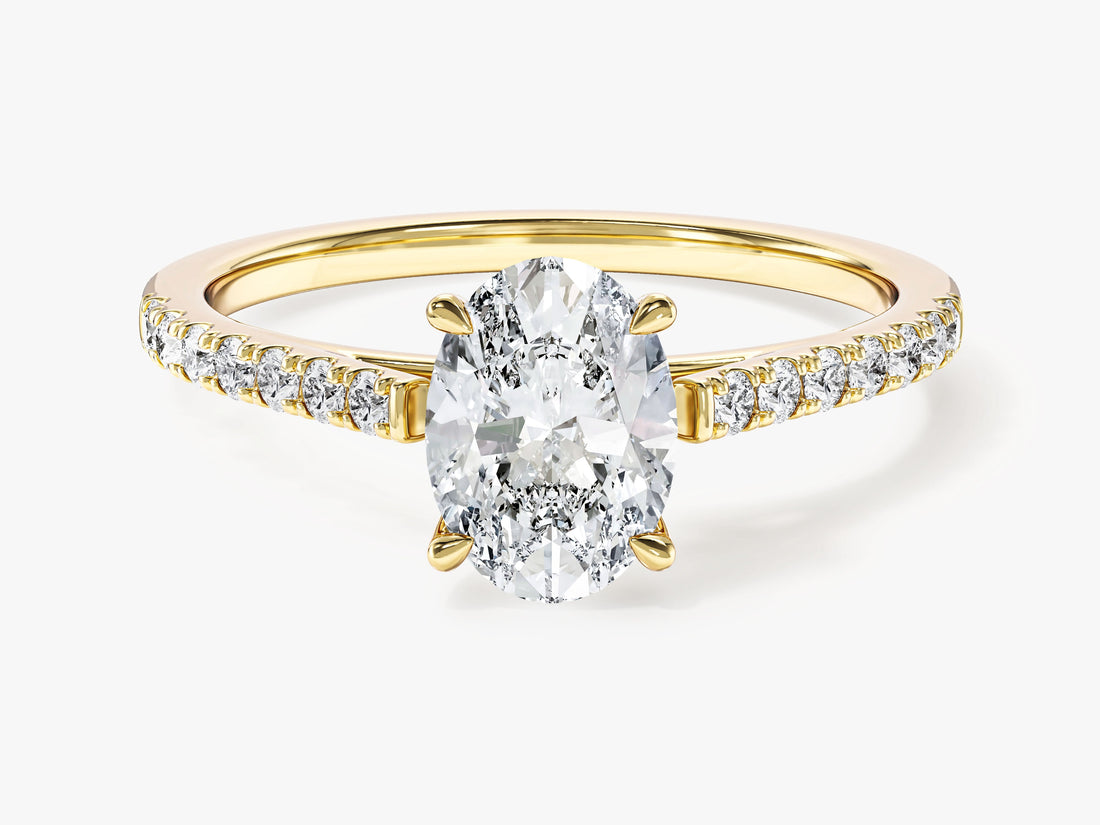Dainty oval moissanite pave engagement ring with cathedral setting in yellow gold, front view