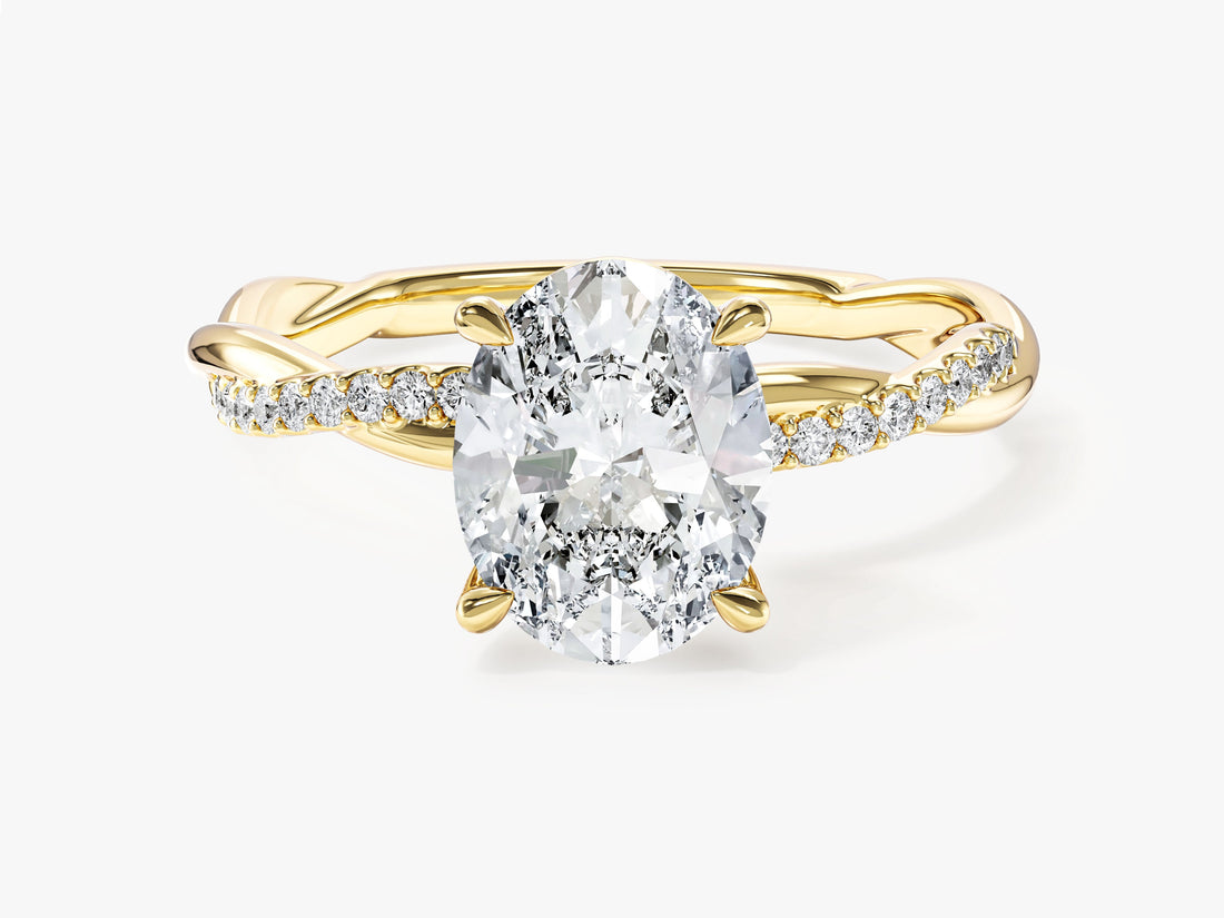 Oval lab grown diamond four prong crossover twisted pave engagement ring in yellow gold, front view