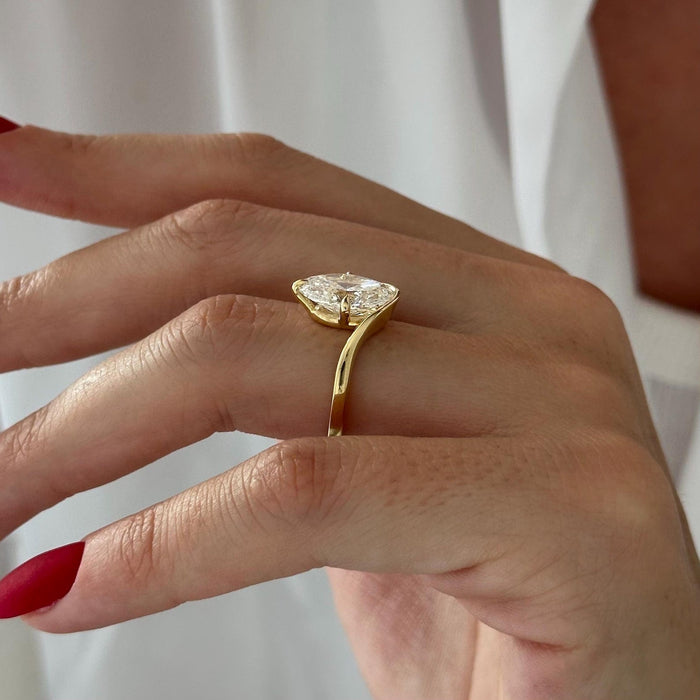 Oval cut moissanite curved wave solitaire engagement ring in yellow gold, view 2