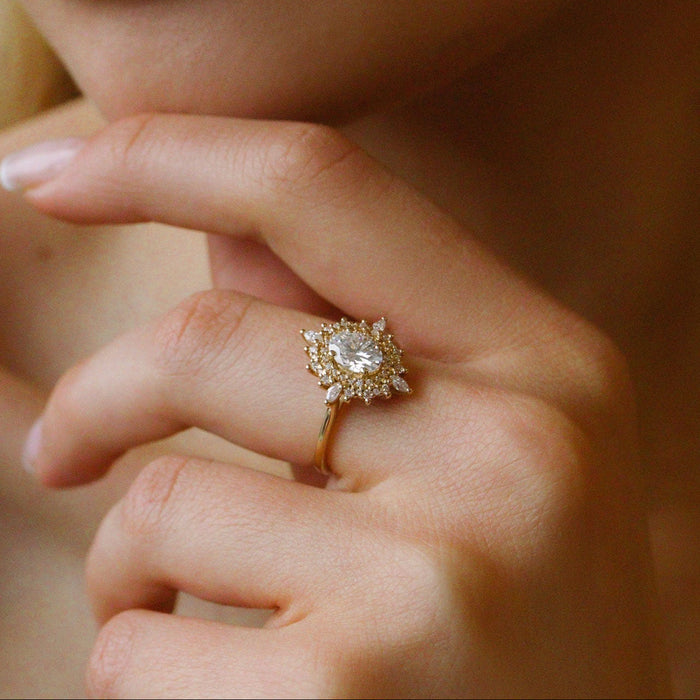 Oval cut moissanite double halo sunburst engagement ring in yellow gold