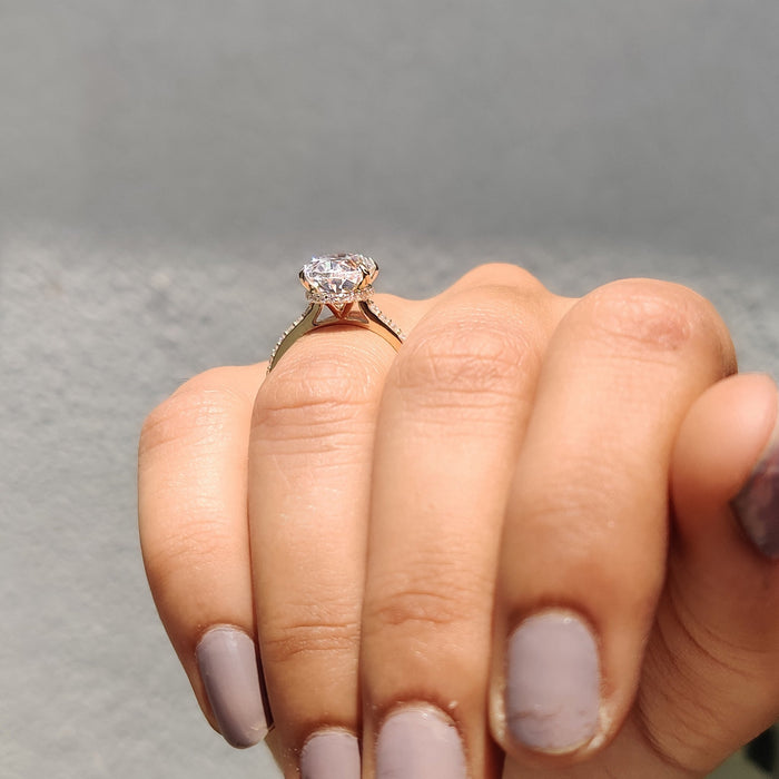 Oval cut moissanite double claw hidden halo engagement ring on a pave shank in rose gold, view 2