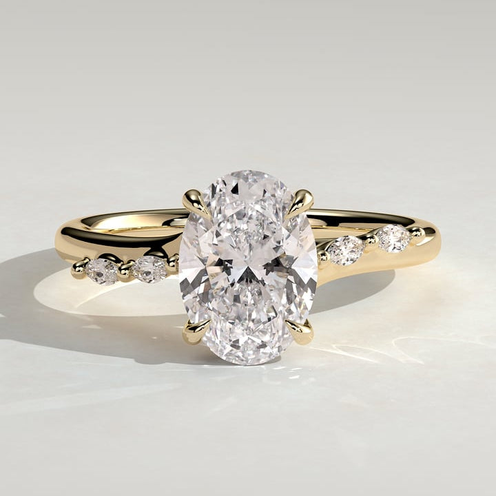 Oval cut moissanite engagement ring with dainty alternating accents in yellow gold