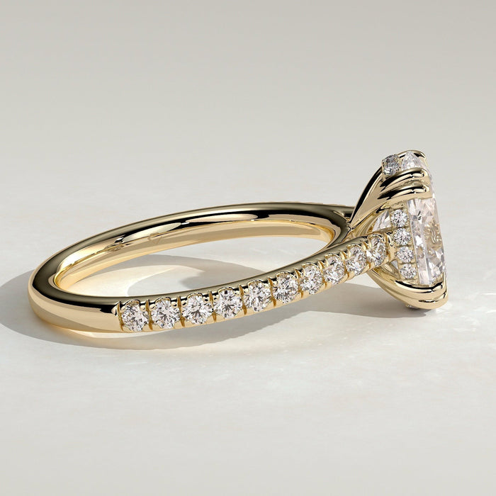 Oval cut moissanite double claw engagement ring on a pave yellow gold band, view 2