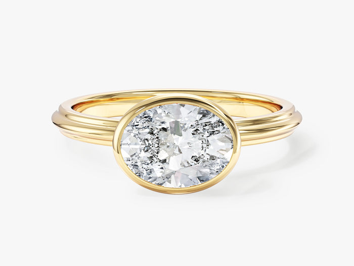 East west oval lab grown diamond bezel solitaire ring with stepped band in yellow gold, front view