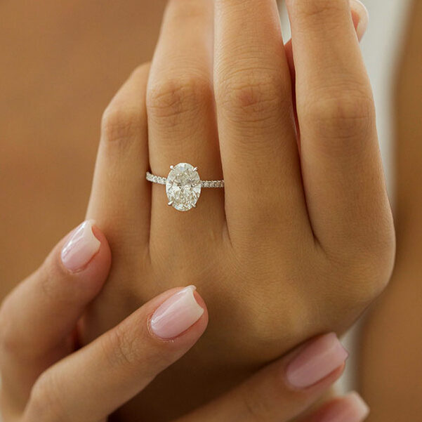Large oval cut moissanite solitaire engagement ring on a fine pave white gold band