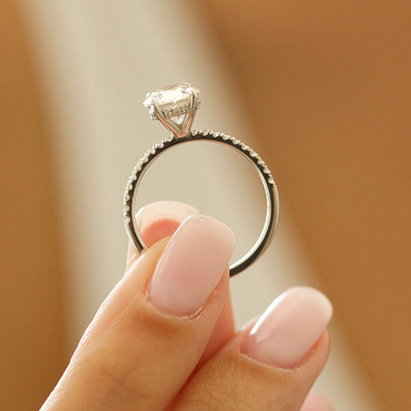 Large oval cut moissanite solitaire engagement ring on a fine pave white gold band, view 2